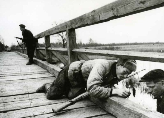 Mikhail Trakhman, Partisans from the Voroshilov unit mine the bridge, Belorussia / Lithuania, December 1943. The Russian Archives of Documentary Films and Photographs.