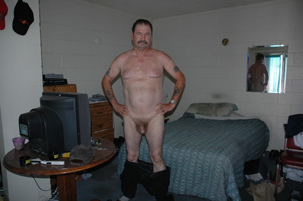 Zoe Strauss, Man on Stairs Standing Nude in Apartment, Las Vegas, 2005.