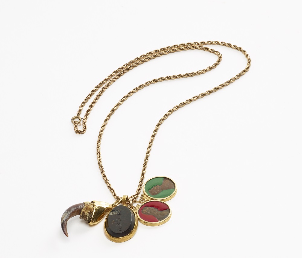 Robert Mapplethorpe, Necklace with animal claw, stone amulet, and pennies coated with resin, held with gold fixings on a gold chain, ca. 1972.
